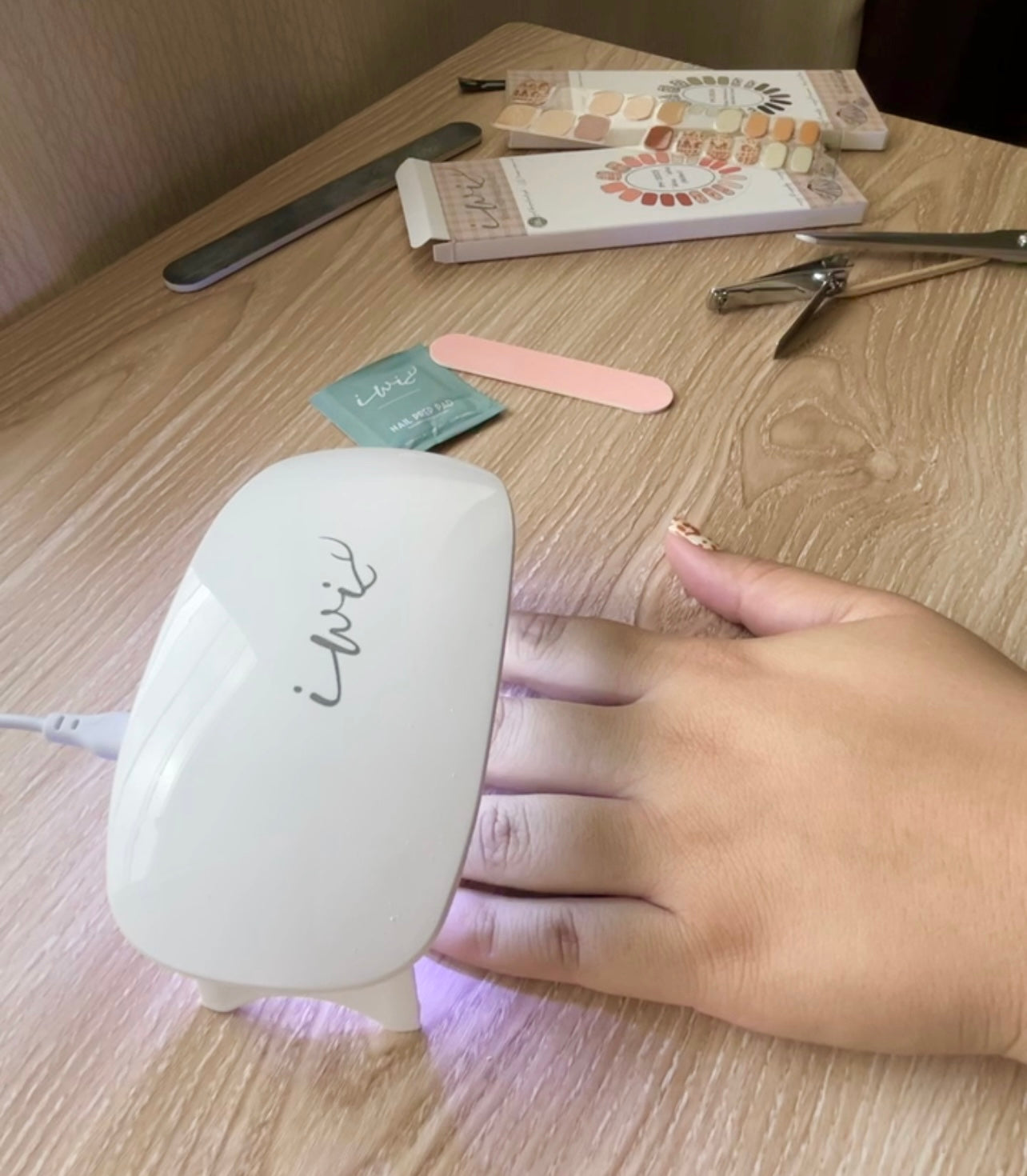 Pop-Up Mākeke - Iwi Nails - Gel Nail Strips - Palaka (Pastel Guava) - Gel Lamp in Use
