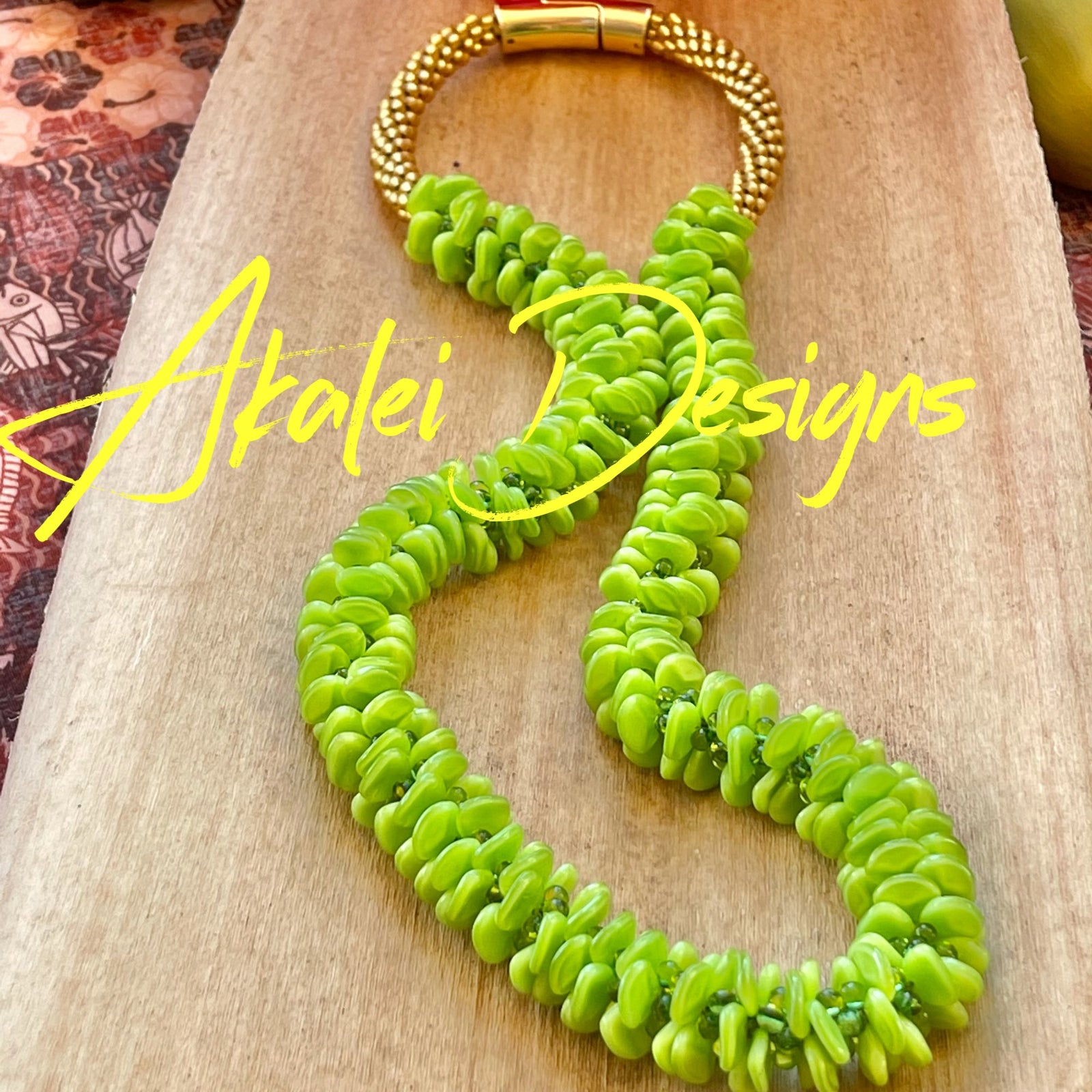 Pop-Up Mākeke - Akalei Designs - Bright Green Orchid Lei - Laid Down - With Logo