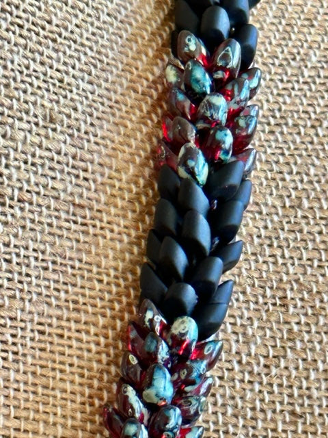 Pop-Up Mākeke - Akalei Designs - Transparent Red Picasso with Matte Black Dragon Scales "Kane" Necklace - Close Up