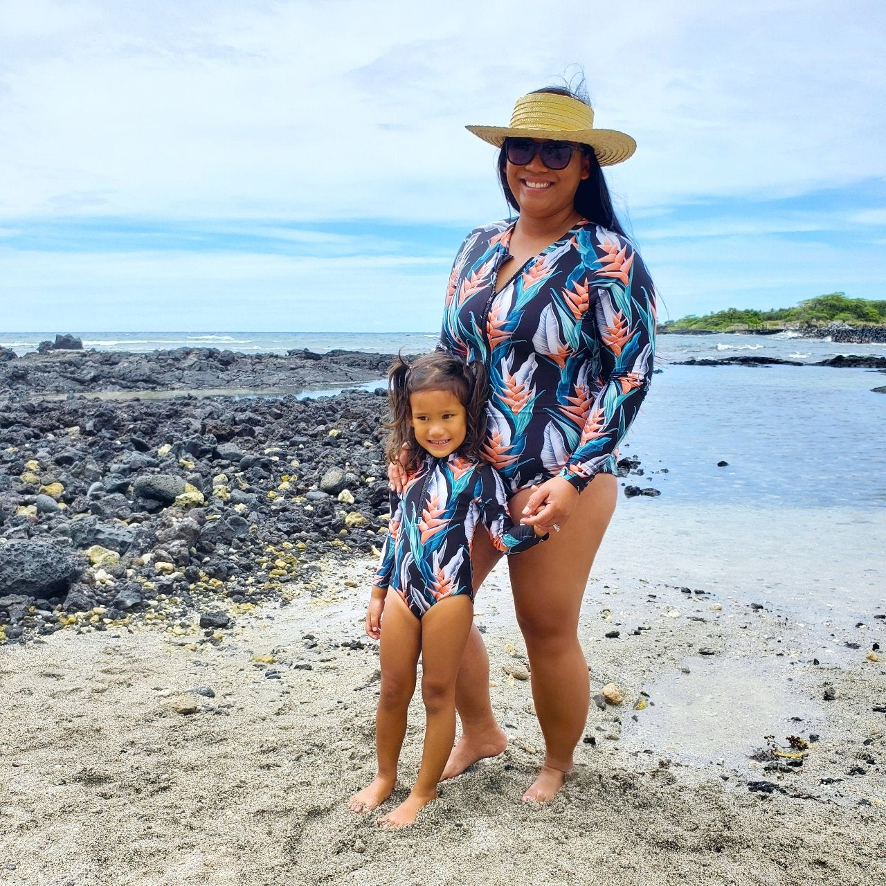 Pop-Up Mākeke - IwaWhy - Jacquelyn Long Sleeve Women's Swimsuit - Orange Heliconia - Front View with Keiki