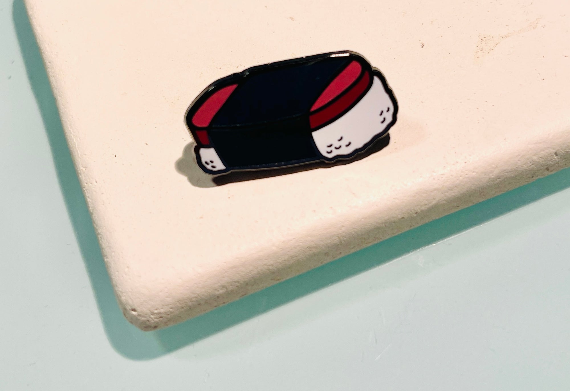 Pop-Up Mākeke - Mahea Leah - Spam Musubi Enamel Pin - In Use